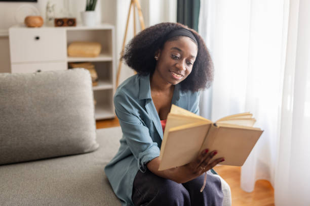 istock Content woman enjoying a book in a serene setting 2166591997