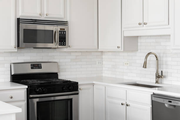istock A kitchen detail with white cabinets and marble subway tile backsplash. 2166592035