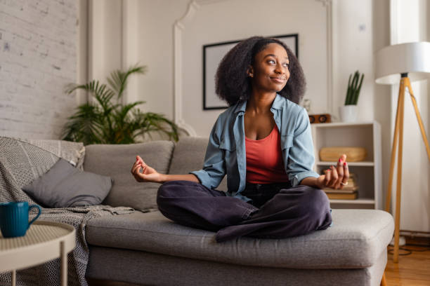 istock Content woman meditating, sitting cross-legged indoors 2166592055