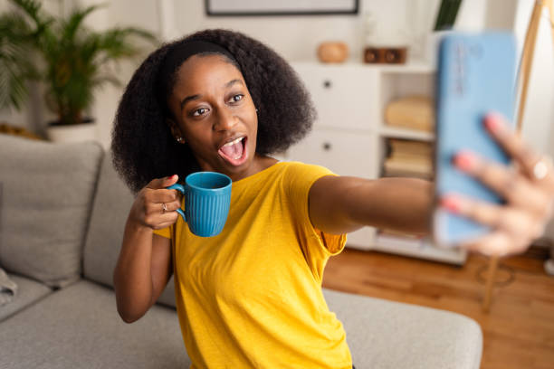 istock Excited woman posing for selfie with blue mug 2166592340