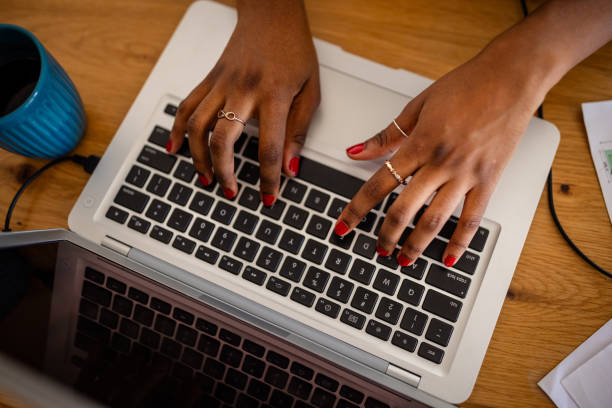 istock Hands typing on keyboard with red nails and blue cup 2166592720