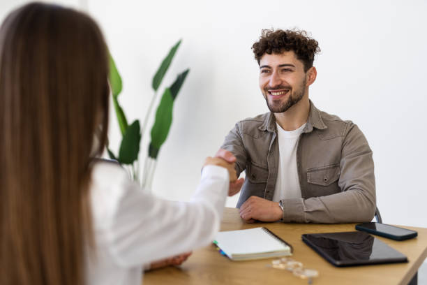 istock Young businesswoman doing handshake with man at office 2166593419