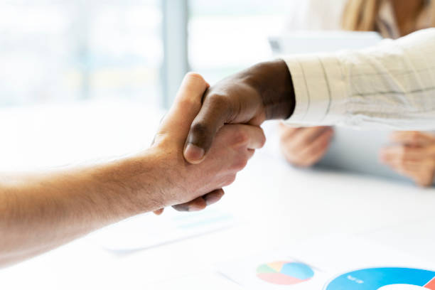 istock Business people shaking hands during meeting closeup, selective focus 2166594121