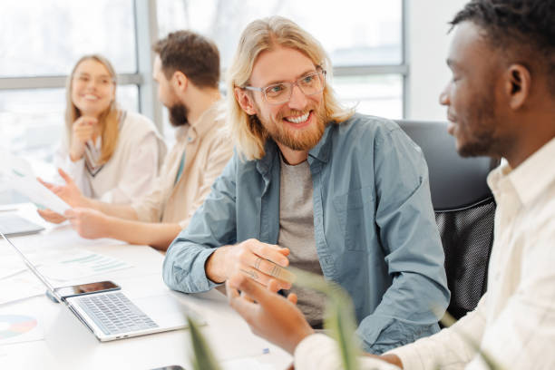 istock Two businessmen having a meeting while sitting at desk in modern office 2166594150