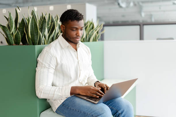 istock Serious professional, freelancer working on his laptop in a modern office space 2166594285