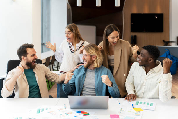istock Excited diverse team, happy colleagues celebrating success in modern office 2166594409