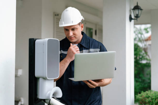 istock Qualified technician working with laptop for home EV station. Synchronos 2166595471