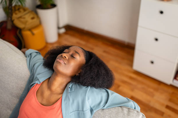 istock Person relaxing with arms spread on a grey sofa. 2166595633