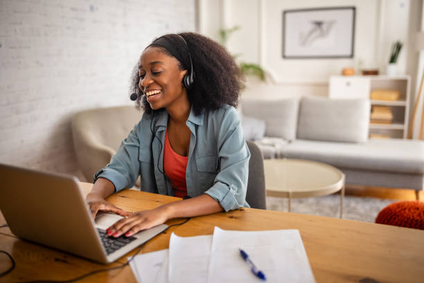 istock Person wearing headset working on a laptop at desk 2166595918