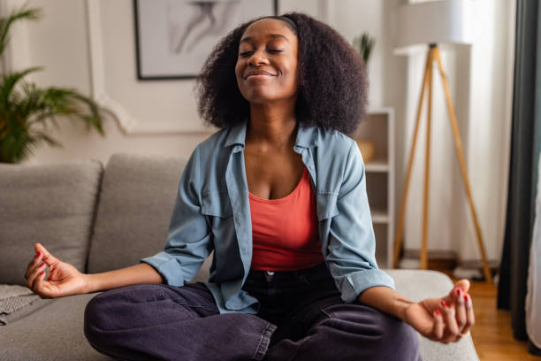 istock Serene woman meditating, sitting cross-legged indoors 2166596582