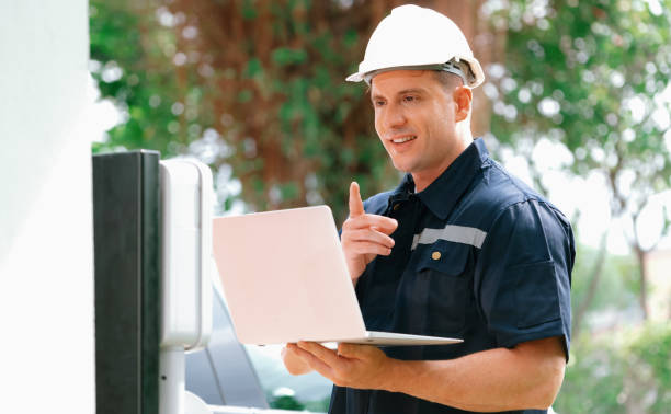 istock Qualified technician working with laptop for home EV station. Synchronos 2166596810