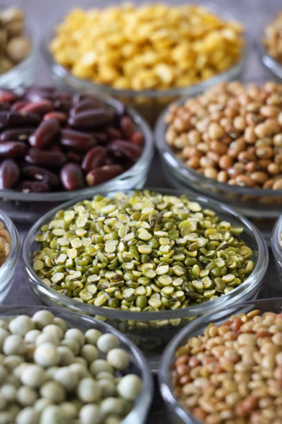 istock Close-up image group glass bowls with piles pulses, nuts and seeds, split olive green lentils, dried green peas, horse gram (Macrotyloma uniflorum), moth beans (Vigna aconitifol), dried red kidney beans (rajma), split yellow lentils (pigeon peas) 2166597607