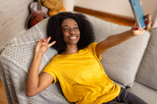 istock Woman capturing a cheerful moment with peace sign 2166597874