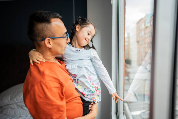 Father with daughter at home - including a child girl with down syndrome