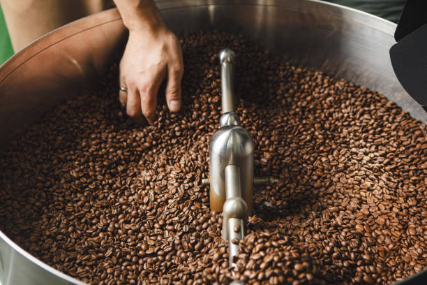 istock Hand Checking Coffee Bean Quality in Rotating Cooling Tray 2166600691