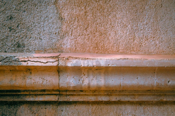 Well worn concrete ledge with cracks and stains