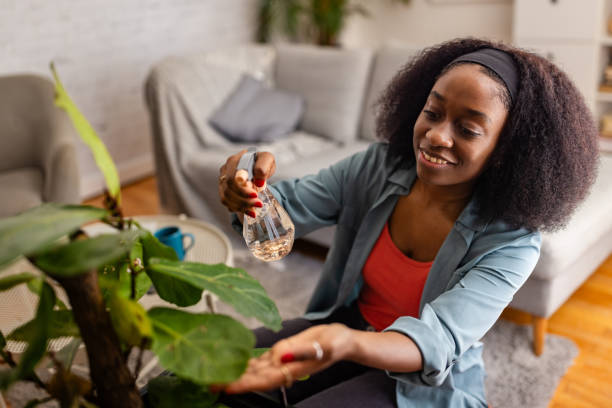 istock Woman nurturing her indoor plant, feeling content and happy 2166602949