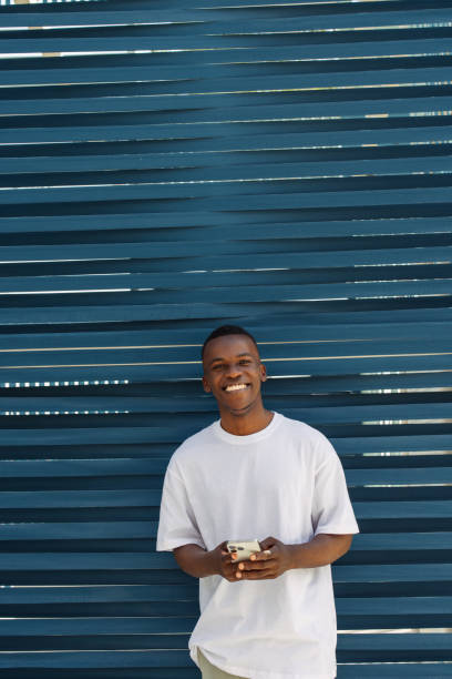 istock Ecstatic young man using trendy smartphone, smiling joyfully, millennial guy enjoy new mobile application 2166602996