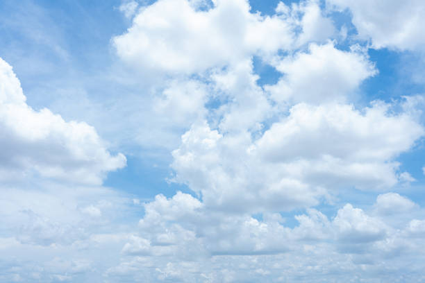 A bright blue sky with fluffy white clouds on a clear summer day