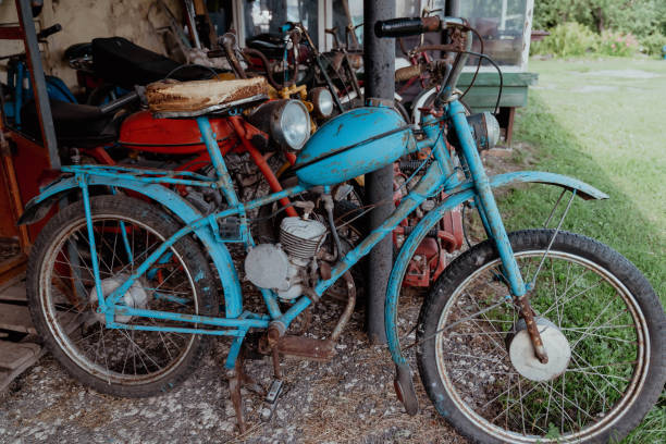 istock A vintage motorized bicycle is parked in a rustic shed 2166604502
