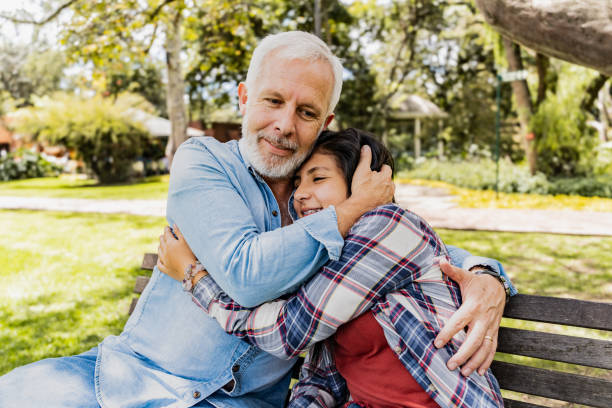 istock Father and daughter embracing on the park 2166604749