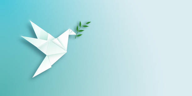 istock International Day of Peace. Flying dove with olive branch on light background. 2166604854