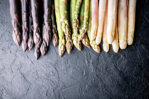 istock Green asparagus sprout on black board 2166605451