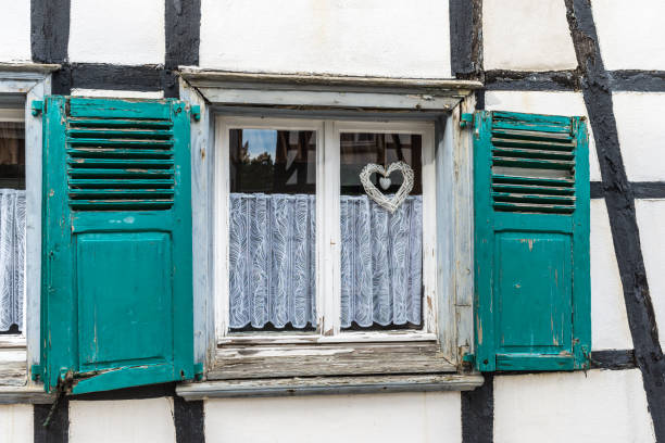 Hattingen, Germany - September 27, 2023: Window with shutters in an old house: traditional German half-timbered architecture in Hattingen, North Rhine-Westphalia, Germany.