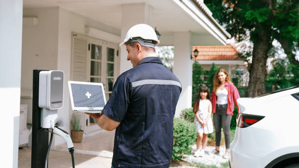 istock Qualified technician working with laptop for home EV station. Synchronos 2166607743