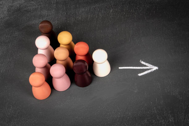 istock Direction indication concept. Wooden human figures on a chalkboard background 2166611789