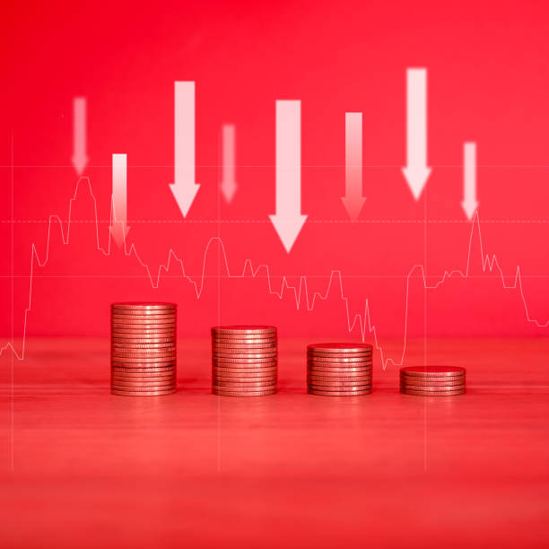 istock Stack of money coin and down arrow with red filter 2166611939