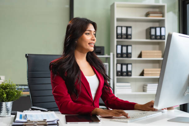 istock Business women hand working with tablet and laptop computer with documents on office desk in modern office. 2166614408