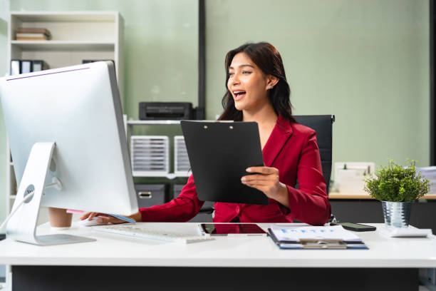 istock Business women hand working with tablet and laptop computer with documents on office desk in modern office. 2166614455