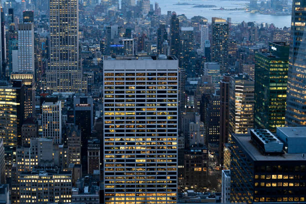 New York, New York City, United States, April 11, 2023 - Manhattan skyscraper and office window of a glass skyscraper at dusk, modern architecture on the banks of the Hudson River in New York City.