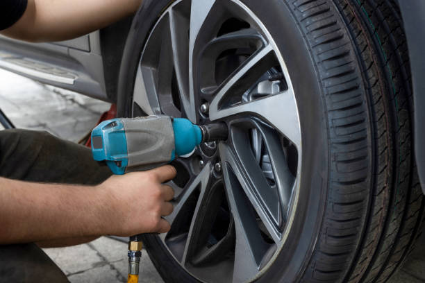 istock Mechanic changing wheel on car with pneumatic wrench 2166615538
