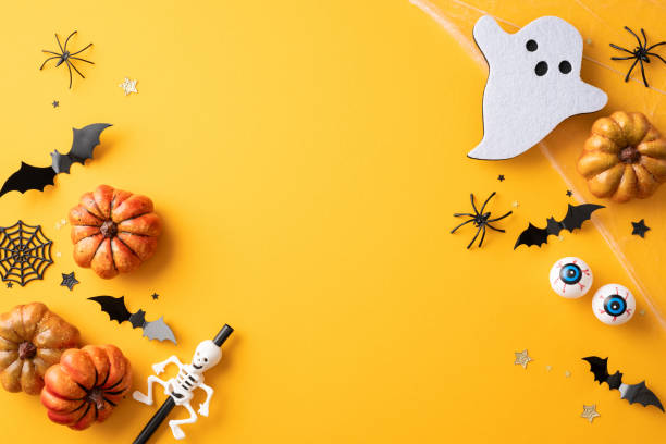 istock Colorful Halloween decorations featuring pumpkins, ghosts, bats, spiders, and web on a yellow background. Perfect for Halloween or autumn themed designs 2166615860