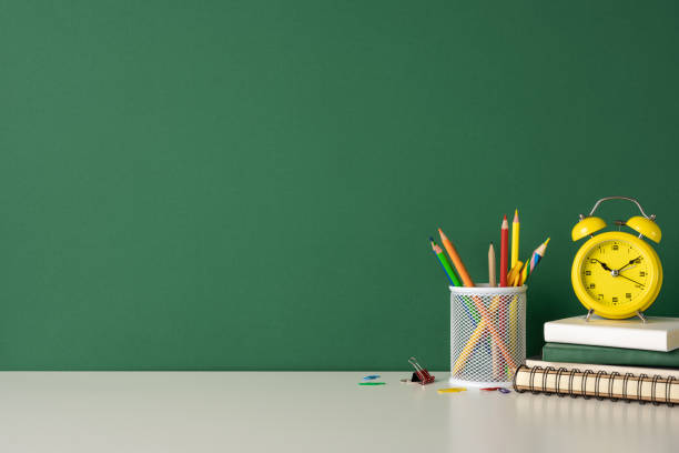 istock A back to school concept featuring various school supplies and a yellow clock on a desk 2166615862