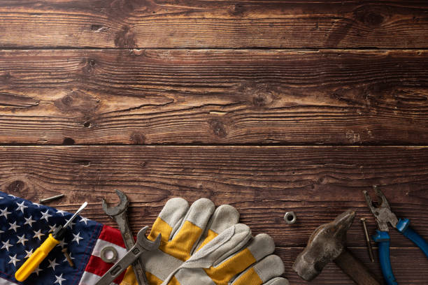 istock Labor Day concept with various tools, USA flag, and work gloves on a rustic wooden background 2166615895