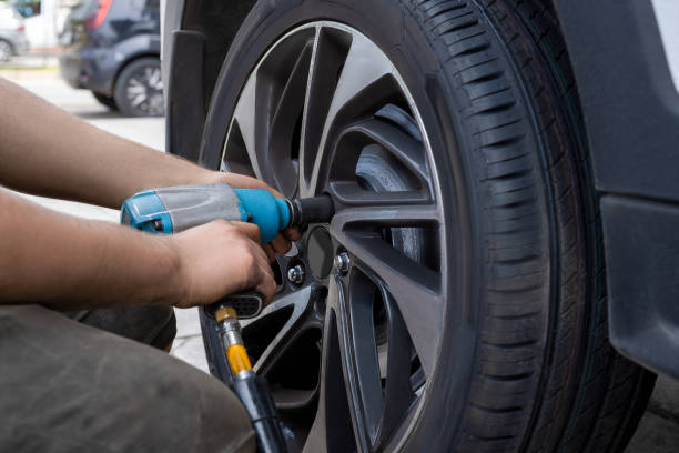 istock Mechanic changing wheel on car with pneumatic wrench 2166616025