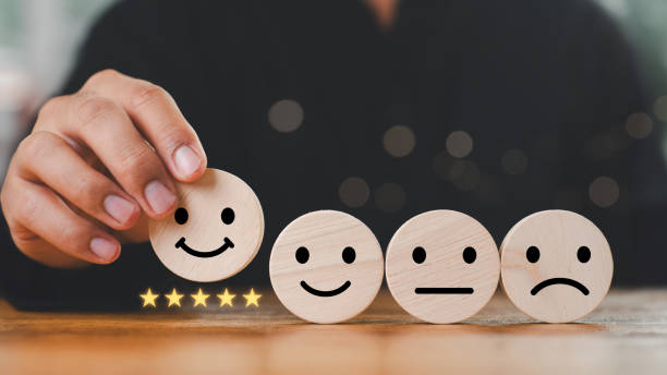 istock customer services best excellent business rating experience. Satisfaction survey concept. Hand of a businessman chooses a smile face on wood block circle. 5 Star Satisfaction. 2166617032