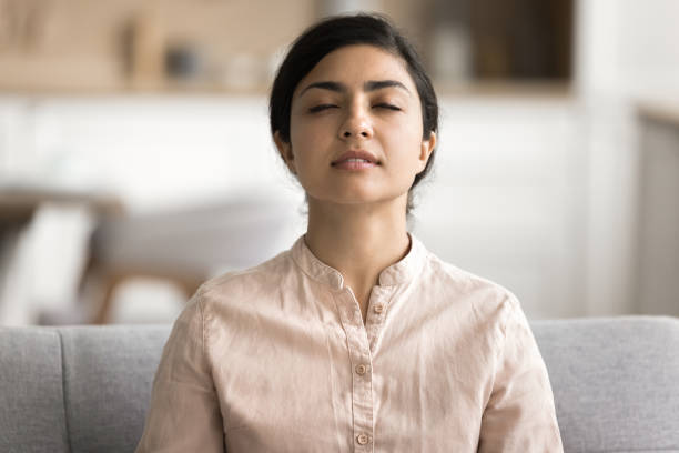 istock Woman meditating with eyes closed, boost state of inner peace 2166619485