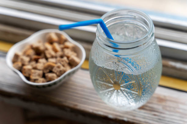 istock Cold drink with a straw and snack bowl on a wooden surface 2166621058