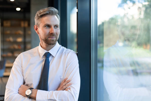 istock Young handsome businessman smiling in an office environment 2166621086