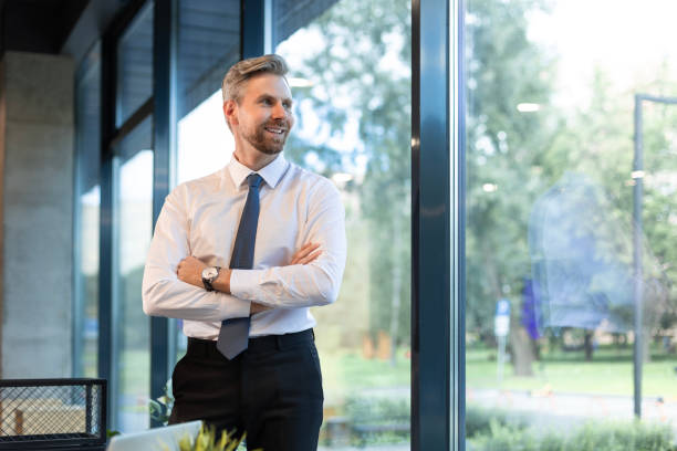 istock Young handsome businessman smiling in an office environment 2166621118