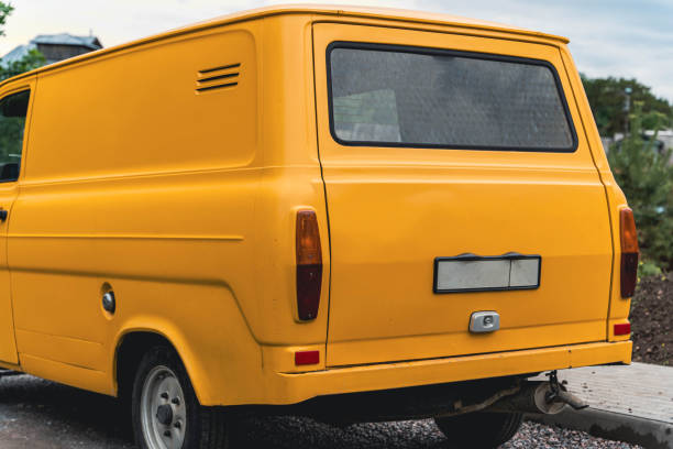 istock A yellow vintage van is parked on a street. 2166623921