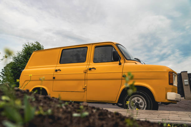 istock A yellow van parked on a paved street 2166623923