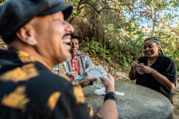 Friends playing cards on public park