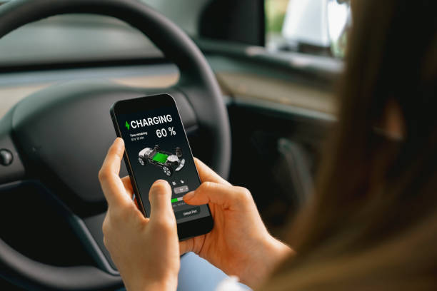 istock Young woman inside the vehicle, checking EV vehicle's application. Exalt 2166628538