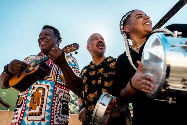 istock Friends singing and playing musical instruments during party on rooftop 2166629064