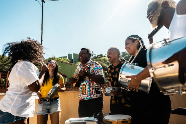 istock Friends singing and playing musical instruments during party on rooftop 2166629084